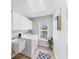 Well-lit laundry room with white cabinets, modern washer and dryer, and bright window at 5306 19Th W Ave, Bradenton, FL 34209
