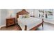 Well-lit bedroom with king bed, side tables, and backyard pool view at 5306 19Th W Ave, Bradenton, FL 34209