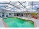 Enclosed pool with covered patio, lounge chairs, and tropical landscaping offers a relaxing outdoor retreat at 5306 19Th W Ave, Bradenton, FL 34209