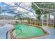 Beautiful screened pool featuring a brick-lined pool edge and lush garden landscape at 5306 19Th W Ave, Bradenton, FL 34209