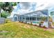 Screened-in pool area with patio, plantings, and partial backyard view enhances outdoor living at 5306 19Th W Ave, Bradenton, FL 34209