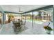 Inviting screened-in pool area with outdoor dining set, lush greenery, and comfortable lounge chairs at 5306 19Th W Ave, Bradenton, FL 34209