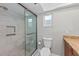 Updated bathroom features a glass shower door, seat, and built-in niche at 7118 11Th W Ave # 7118, Bradenton, FL 34209