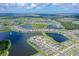 Wide aerial view showcasing the community layout with interconnected ponds, homes and lush surroundings at 9018 Sunray Cv, Parrish, FL 34219