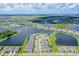 Beautiful aerial view of the community showcasing ponds, meticulously landscaped homes, and neighborhood streets at 9018 Sunray Cv, Parrish, FL 34219