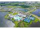 Stunning aerial view of the community clubhouse amenities, including the pool and tennis courts at 9018 Sunray Cv, Parrish, FL 34219