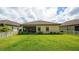 Large backyard with screened patio and grassy area at 220 Capriana Ct, Nokomis, FL 34275