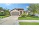 Beautiful one-story home with a two-car garage and well-manicured lawn at 220 Capriana Ct, Nokomis, FL 34275