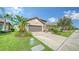 Single-story home with attached garage and nicely landscaped front yard at 220 Capriana Ct, Nokomis, FL 34275