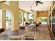 Outdoor clubhouse patio with tables and seating at 220 Capriana Ct, Nokomis, FL 34275