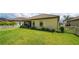 Spacious backyard with screened patio, lush landscaping and a white fence at 220 Capriana Ct, Nokomis, FL 34275