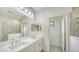 Elegant bathroom with double vanity, large mirror, and separate shower at 220 Capriana Ct, Nokomis, FL 34275