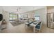 Open living and dining area with sliding doors leading to patio at 220 Capriana Ct, Nokomis, FL 34275