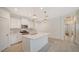 Modern kitchen with white cabinets, stainless steel appliances, and quartz countertops at 220 Capriana Ct, Nokomis, FL 34275