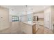 Open concept kitchen with island, stainless steel appliances, and view to living room at 220 Capriana Ct, Nokomis, FL 34275