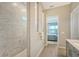 Spa-like bathroom with a walk-in shower and marble tile at 9018 Sunray Cv, Parrish, FL 34219