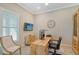Bright home office with a large wooden desk and built-in shelving at 9018 Sunray Cv, Parrish, FL 34219