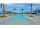 Large resort-style pool with palm trees and lounge chairs at 9018 Sunray Cv, Parrish, FL 34219