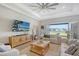 Relaxing living room featuring large TV and water view at 9018 Sunray Cv, Parrish, FL 34219
