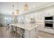 Spacious kitchen with white cabinets, quartz countertops, and island at 9018 Sunray Cv, Parrish, FL 34219