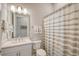 Clean bathroom with a shower/tub combo and striped shower curtain at 9018 Sunray Cv, Parrish, FL 34219