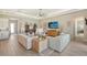 Relaxing living room featuring a sectional sofa and a large TV at 9018 Sunray Cv, Parrish, FL 34219