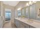 Double vanity bathroom with a view into bedroom and walk-in shower at 9018 Sunray Cv, Parrish, FL 34219