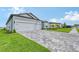 Two-story home with gray siding, two-car garage and paver driveway at 9018 Sunray Cv, Parrish, FL 34219