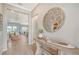 Bright and airy entryway with a rustic console table and large mirror at 9018 Sunray Cv, Parrish, FL 34219