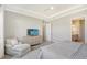 Primary bedroom with a chaise lounge and ensuite bath at 9018 Sunray Cv, Parrish, FL 34219