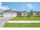 Two-story home with gray siding, two-car garage and lush landscaping at 9018 Sunray Cv, Parrish, FL 34219