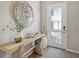Modern entryway with stylish decor and a white door with glass panes at 9018 Sunray Cv, Parrish, FL 34219
