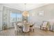 Bright dining room with a large wooden table and seating for six at 9018 Sunray Cv, Parrish, FL 34219