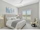 Comfortable bedroom with a queen-size bed and large window with plantation shutters at 9018 Sunray Cv, Parrish, FL 34219