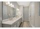Double vanity bathroom with a large mirror and modern lighting at 9018 Sunray Cv, Parrish, FL 34219