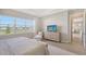 Primary bedroom with lake view and dresser at 9018 Sunray Cv, Parrish, FL 34219