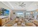 Bright living area with large windows, comfy sofas, and a view at 9018 Sunray Cv, Parrish, FL 34219