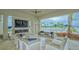 Comfortable outdoor lounge area with fireplace and pool view at 9018 Sunray Cv, Parrish, FL 34219