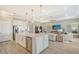 Modern kitchen island with white cabinetry and stainless steel appliances at 9018 Sunray Cv, Parrish, FL 34219
