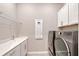 Bright laundry room featuring washer, dryer, and ample storage at 9018 Sunray Cv, Parrish, FL 34219
