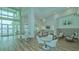 Clubhouse lounge with seating areas, large windows, and a view of the pool at 9018 Sunray Cv, Parrish, FL 34219