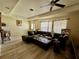 Living room featuring an L-shaped sofa and light-colored flooring at 361 Porpoise Rd, Venice, FL 34293