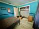Bedroom with teal walls, a double bed, and a ceiling fan at 361 Porpoise Rd, Venice, FL 34293
