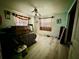 Simple bedroom with light flooring, plaid curtains, and a ceiling fan at 361 Porpoise Rd, Venice, FL 34293