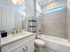 Neat bathroom with a shower/tub combo, white vanity, and storage at 341 Villoresi Blvd, Nokomis, FL 34275