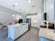 Modern kitchen with white cabinets, quartz countertops, and stainless steel appliances at 341 Villoresi Blvd, Nokomis, FL 34275