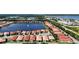 Aerial view of a large community with houses surrounding a lake at 341 Villoresi Blvd, Nokomis, FL 34275