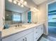 Modern bathroom with double vanity and a large mirror at 341 Villoresi Blvd, Nokomis, FL 34275