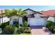 Single-Gathering home with a two-car garage and landscaped yard at 341 Villoresi Blvd, Nokomis, FL 34275