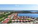 Aerial view of houses with red tile roofs near a lake at 341 Villoresi Blvd, Nokomis, FL 34275